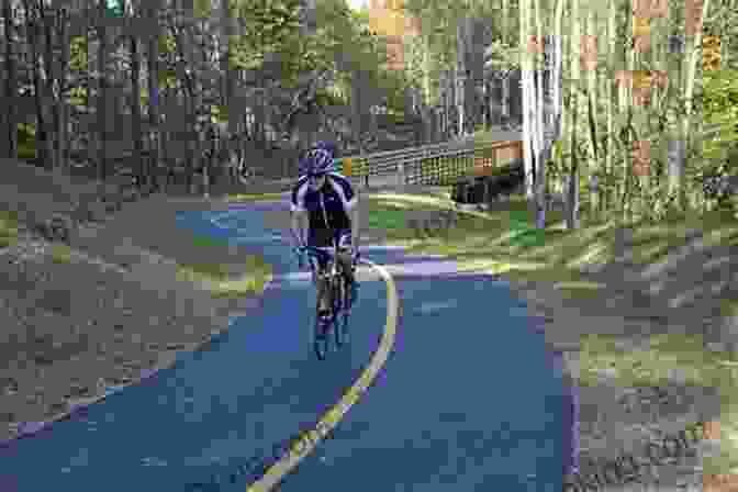 A Cyclist Riding Along The Virginia Capital Trail, Surrounded By Lush Greenery And A Winding Path Insiders Guide To Richmond VA (Insiders Guide Series)
