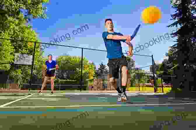 Two Pickleball Players Hitting A Ball On A Court; One Player Is Smiling And Holding A Pickleball Racket Inside The Game: The Madness Metrics And Methods Of Winning Pickleball